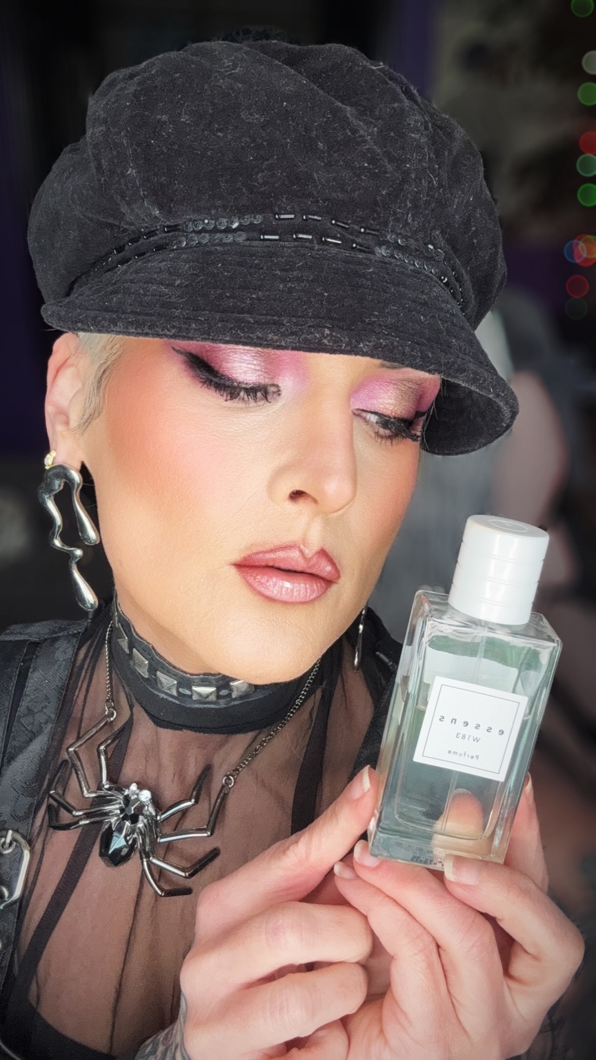 Becci holding an Essens fragrance bottle