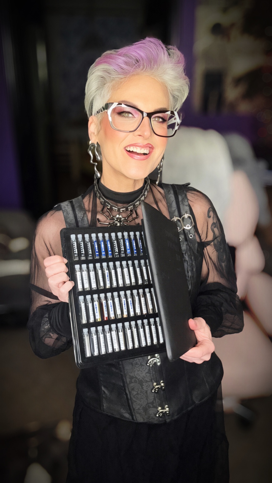 Becci holding a fragrance sample portfolio
